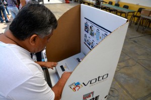 A voter in Lima'a Barranco district being shown how to use the new electronic voting system. Photo: Paula Dupraz-Dobias 