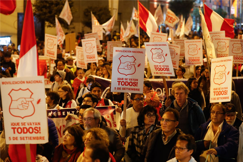 Protestors march in downtown Lima earlier this month to demand the resignation of all members of Congress and the Executive